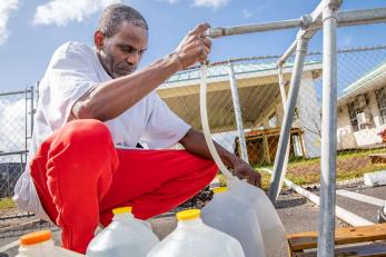 Bahamian filling water jugs.