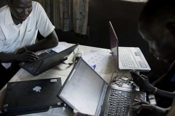 A group of people using laptop computers.