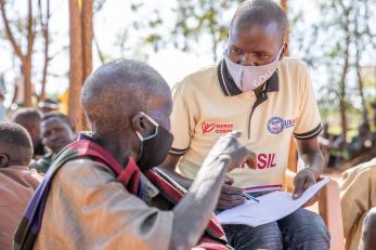 Mercy Corps team member, James Longok, speaks with people in Karamoja during a peace-building session.