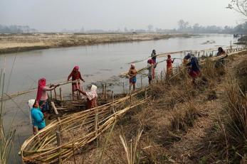 Women in Badabaika, Nepal build bamboo spurs to protect their land from floods.