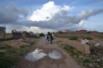 Two people walking on a path together.