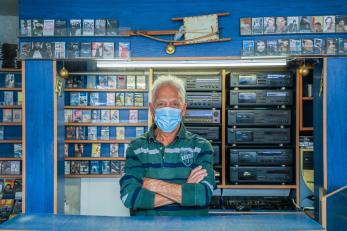 A business owner standing in their store.