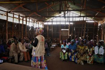 A presenting speaking to a group of people.