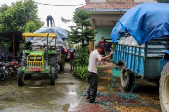 People unloading non-food item kits.