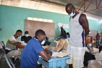 A farmer signing up to receive supplies as part of a long-term recovery program.