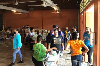 In Cataño, Puerto Rico, volunteers at Association Pro Juventud y Comunidad de Barrio Palmas, a Mercy Corps Resilience Hub, prepare supplies for distribution. 