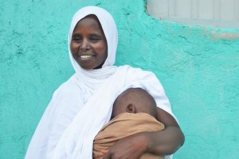 An adult holding a baby.