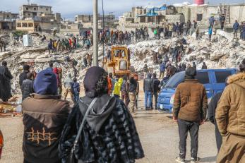 In Harim Syria, people and rescue crews gather around collapsed buildings following the 7.8 magnitude earthquake.
