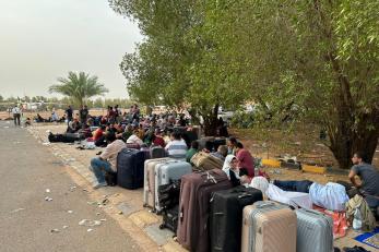 People wait to be evacuated near an airport in Omdurman, Sudan, April 26, 2023. As conflict continues in Sudan, many people have fled to neighboring countries. Photo by Xinhua via Getty Images