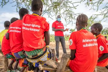 Mercy Corps’ Karamoja South Team Leader for the APOLOU program, speaks to girls participating in a safe space program.