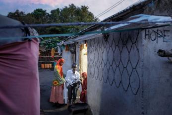 A family sitting outside their home.