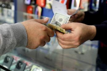 hands exchanging currency.