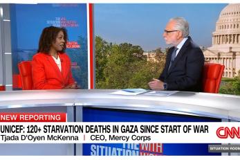 Mercy Corps CEO being interviewed by CNN Anchor.