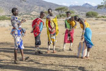 Kenyan women meeting in the outdoors.