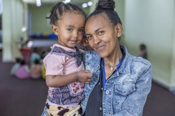 Ethiopian mother and daughter smiling together.