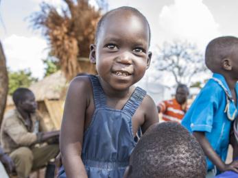 Uganda boy surrounded by people