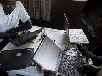 A group of people using laptop computers.