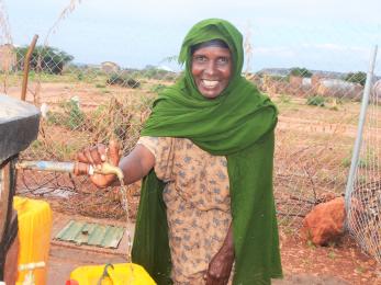 woman outside at water station