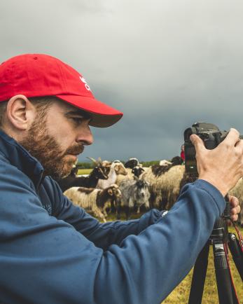 Ezra Millstein, senior content producer, captures Mercy Corps’ impact on people and communities with his camera. Here, he photographs herders in Altan-Ovoo, Mongolia, working with us to keep their cattle, sheep and other animals free of insects and disease. Photo: Sean Sheridan for Mercy Corps