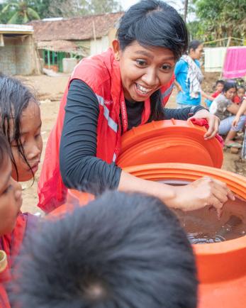 A group of young people receive clean water.