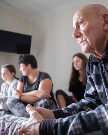 A family from Bakhmut in their temporary apartment in the Donetsk region of Ukraine, which has been embroiled in active conflict since the early days of the war.