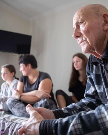 A family from Bakhmut in their temporary apartment in the Donetsk region of Ukraine, which has been embroiled in active conflict since the early days of the war. 