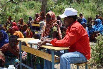 Abdi Aziz Ali, one of Mercy Corps' mobile health team leaders, discusses healthy hygiene and nutrition habits with mothers who visit our outpatient clinic.