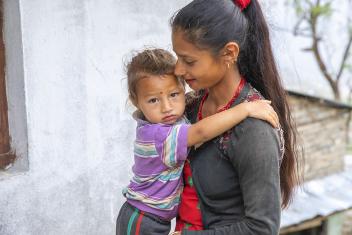 "There was just dust, dust everywhere from the fallen houses," Sushma recalls. "There was a store here that was only half destroyed. We got some food out of the store to at least feed the children." She is pictured here with her son, Rashik.