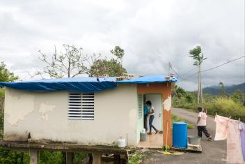 Mercy Corps staffers Karla Peña and Pardis Barjesteh enter a damaged house in the mountain town of Maricao. Felicita Dragones lives alone in the house but rode out the storm with her daughter. When she returned to see the house flooded and the roof gone, she burst into tears.