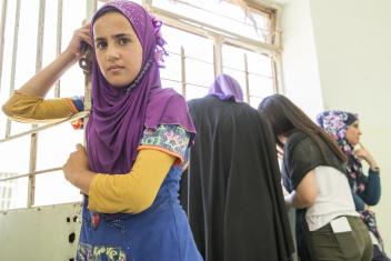 Khawla, 12, waits with her father to receive a cash distribution from Mercy Corps. Since July 2016, Mercy Corps has reached over 12,000 families in Mosul with emergency cash distributions of $400 so they can buy the urgent items they need now.