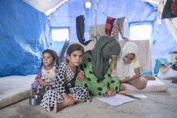 Left to right: Fatima, 5; Siham, 6; Freeal,15; and Amara, 12, draw on the floor inside their family's tent at the Jeddah displacement camp. Temperatures inside the tents can be sweltering as outside temperatures rise above 100 degrees.