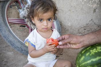Wia eats a freshly harvested tomato. Syria's future depends on its communities being able to provide sustainable sources of income for families like this one. Mercy Corps is committed to helping Syrians harness their expertise to provide a better, stronger future for their families. “I gave my life to this," Abu Goubran says.
