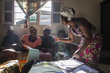 Noella leads her women's group in learning about cholera. Each woman and leader shares her learning with another 15 women.