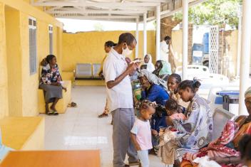 Patients wait outside the Mercy Corps-supported health clinic in Um Rakuba.