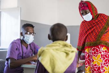 Dr. Mohamed Elmutasim Mahjoub Ahmed (left) and Giday Mohamed Abdulnoor (right) meet with a patient in the health centre. The Mercy Corps-supported clinic is the main medical facility in the camp, supporting an average of 30 to 50 patients per day.