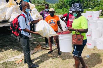 A L’Asile resident picks up a kit of essential supplies. Our next step is to distribute cash assistance to thousands of families so they can purchase what they need most.