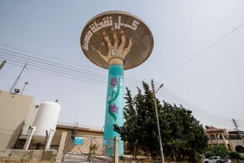 Jordan’s water company, Miyahuna, commissioned murals for their towers like this one depicting a hand carrying the tower’s “cracked plate” in an attempt to save every drop, by artists Wesam Shadid and Ibrahim Tonnerieux.