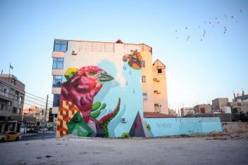 Artist Jerry Rugg (BirdO) depicts Jordan’s national bird, the Sinai rosefinch, emerging from a cornucopia of plants while below a water tap. Households in Mafraq are familiar with this desert bird, which symbolizes resilience and survival with very little water.