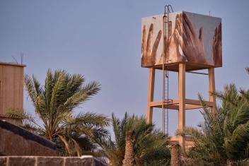 The hands reaching toward the sky are based on photographs taken during a site visit with the community in Azraq and symbolizes the collective effort of water conservation. Artist Guido van Helten painted it on the main water tank of Jordan’s water company, Miyahuna.