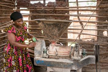 A Tanzanian entrepreneur and her milling machine in Chienjele village. Small business training helps rural communities connect to the national electrical grid and increase livelihood opportunities.