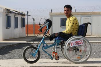 Sami, a Syrian refugee, poses on the adaptive bicycle he used to win a 10K race. Our team at the Zaatari camp in Jordan supports young people with disabilities by building, modifying, and providing accessibility equipment.