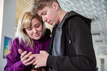 With her two sons, Alla Mabruseva arrived at a shelter in Lviv, Ukraine. The shelter used to be a cultural centre and is supported by Mercy Corps. She fled Mariupol and is reading a message on her phone with news that her parents are still alive in her hometown. “If it wasn't for help centres like this one, no one would be able to get out,” said Alla.