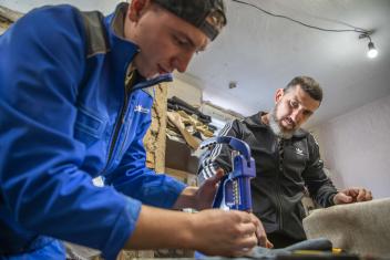 With cash assistance from our team in Ukraine, Volodymyr (right) was able to purchase the equipment he needed to reduce costs, maintain quality craftsmanship, and hire displaced community members.