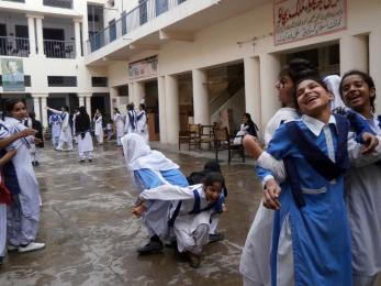 Girls laughing in a group arm lock