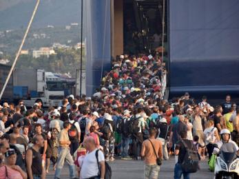 Refugees board the daily ferry from the island of lesbos to athens, greece. those who can't make it onboard must wait another day for the next ferry. photo: graham niven/mercy corps