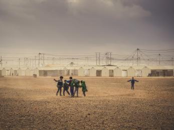 Boys playing near shelters at a refugee camp in jordan
