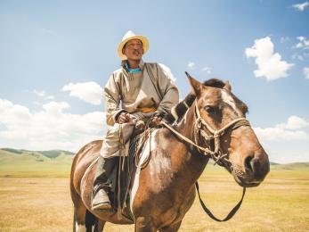 Batsaikhan, 40, is a nomadic herder in central mongolia, where life depends on the dramatic turns of the weather. mercy corps is helping herders like him strengthen their animals so they can earn steady incomes and feed their families through the brutal winter. here, batsaikhan is pictured on horseback.