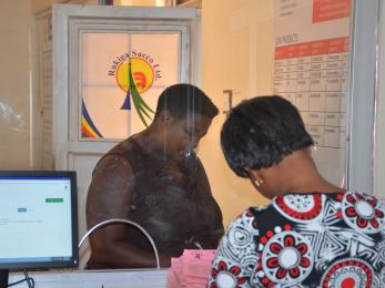 Customer transacting at the counter of rukiga sacco