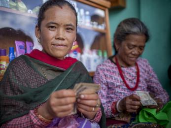 Two women handling money in a shop