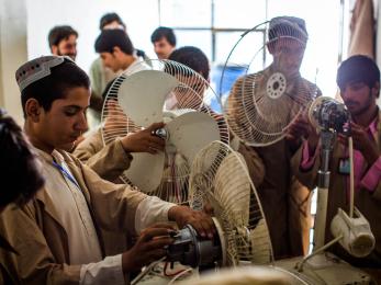 Men working in afghanistan repairing fans